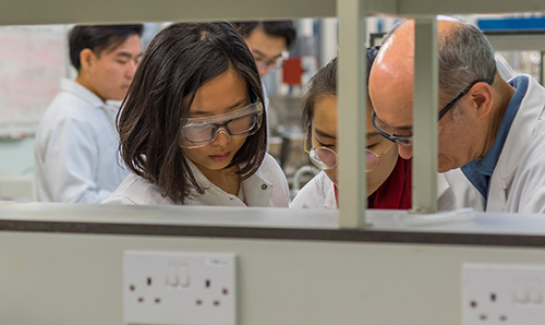 Female students working together in their lab coats